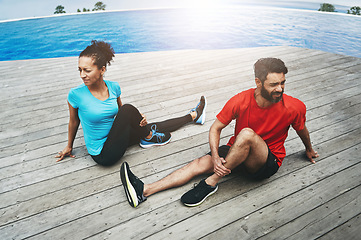 Image showing Stretching, legs and couple in exercise on deck to start fitness, training or outdoor with pool. Runner, workout and people together in preparation for sports, performance and warm up for back