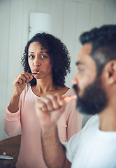 Image showing Couple, brushing teeth and bathroom in morning, dental wellness and worry with thinking in home. Mature man, woman and toothbrush for cleaning mouth together with concern, stress or hygiene in house