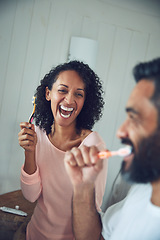 Image showing Couple, brushing teeth and laughing in bathroom, happy and love in morning routine, play or funny joke. People, cleaning mouth and oral hygiene or sanitary or health and wellness, fresh and self care