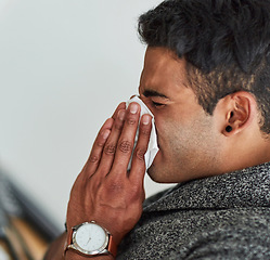 Image showing Profile, hand and blowing nose with a man using a tissue closeup in his home for relief from allergy symptoms. Face, sick with a cold or flu and a young person sneezing due to a virus or hay fever