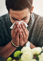 Image showing Face, hand and blowing nose with a man using a tissue in his home for relief from allergy symptoms. Sick, cold or flu disease and a young person ill with a virus due to bacteria, pollen or hay fever