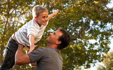 Image showing Dad, child and garden with airplane game, happy bonding and fun morning playing for father and son. Outdoor fun, love and playful energy, man holding boy in air and laughing in backyard together.