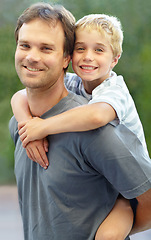 Image showing Piggy back, portrait of father and son in garden, cute bonding together with care and love in backyard. Outdoor fun, support and dad holding playful child with smile, trust and happy man with kid.