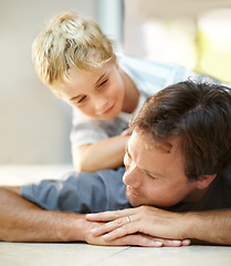 Image showing Smile, relax and dad with son on floor, cute bonding together with care and love in home. Fun, father and child lying on ground in house with happy relationship, trust and support with man and boy.