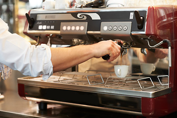 Image showing Coffee machine, closeup and man barista in a cafe making latte, cappuccino or espresso in a cup. Equipment, mug and zoom of male waiter or small business owner working on an order in a restaurant.