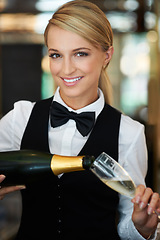 Image showing Champagne, glass and portrait of woman waitress in a elegant restaurant, event or dinner. Happy, smile and young female butler from Australia pour alcohol wine at a luxury party or celebration.