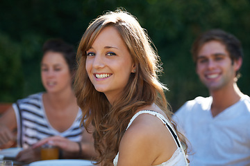 Image showing Happy, woman and portrait in backyard with friends at a table with young people and smile. Lunch, home garden and group ready for eating on a summer break together and relax outdoor of a house