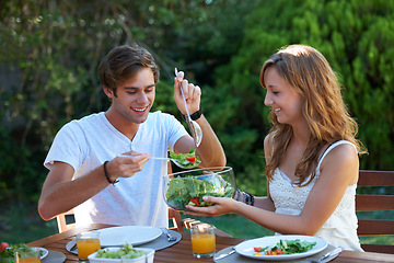 Image showing Happy, friends and food in backyard with salad at a table with hungry young people and smile. Lunch, home garden and group ready for eating with healthy meal together and relax outdoor of a house