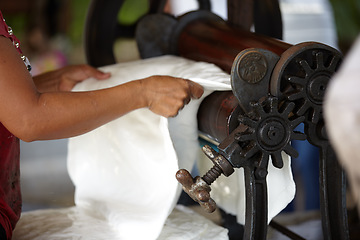 Image showing Plastic, industry and hands of person with roller in workshop, factory and outdoor warehouse. Manufacturing, production and worker with machine for rolling latex, rubber and material plantation