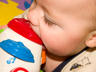 Image showing Closeup of a sweet baby boy with a toy