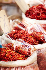 Image showing Chilli, pepper and market for shopping sale, discount or wholesale promotion at vendor store or local trading. Bag of dried fruits, red vegetables and spice for food and flavor with empty background