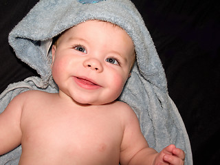 Image showing Happy young baby boy in blue towel