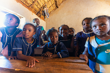 Image showing Happy Malagasy school children students in classroom. School attendance is compulsory, but many children do not go to school.