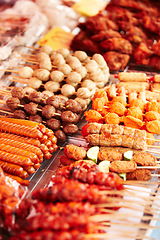 Image showing Meat, skewers and local market with food sale, shopping and choice for retail or small business background. Seller or entrepreneur with sausage, pork and bbq or chicken stick for restaurant or buffet