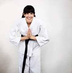 Image showing Woman, karate and bow in portrait, fight and self defense sport, muay thai and training with respect. Athlete, combat and fitness, martial arts and warrior energy with taekwondo and wall background