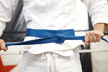 Image showing Karate, hands and belt, fight and sport for self defense with muay thai and person training in gym. Athlete, combat and power with fitness, martial arts and warrior with exercise and taekwondo