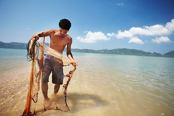 Image showing Fisherman, sea and man with net working, nature and labor with fishing in Thailand and tropical island location. Ocean, job and rope with worker in water to catch fish and beach with environment