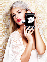 Image showing Portrait, photographer and woman with retro camera, fashion style and trendy. Face, vintage lens and model with gear for photoshoot, film and photography for picture on a paisley art background