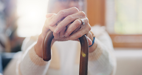 Image showing Walking stick, hands and senior woman with a disability in home, apartment or retirement with support for injury. Elderly, closeup or person with wood cane to help balance or mobility with arthritis