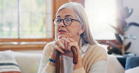 Image showing Home, thinking and senior woman with anxiety, sad and retirement with depression, mental health or dementia. Mature person, old lady or pensioner with walking stick, alzheimer and relax in a lounge