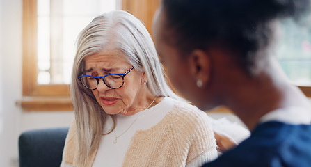 Image showing Senior, sad woman speaking or nurse with support or results in consultation for bad news or cancer. Stress, depression or caregiver with a crying mature patient for empathy, sympathy or help in home