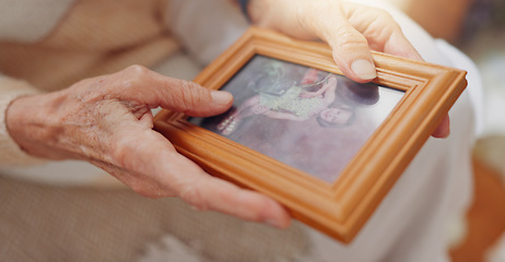 Image showing Frame, picture and hands of senior person for nostalgia, memories and thinking of past in home. Retirement home, elderly and closeup of photo to remember, mourning and depression with Alzheimers