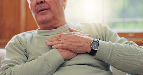 Image showing Hands, heart attack or condition with a senior man in pain closeup in the living room of his retirement home. Healthcare, chest or cardiac arrest with an elderly person breathing for lung oxygen