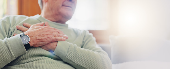 Image showing Hands, heart attack or condition with a senior man in pain closeup in the living room of his retirement home. Healthcare, chest or cardiac arrest with an elderly person breathing for lung oxygen