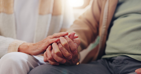 Image showing Holding hands, empathy and an elderly couple closeup in their home for love, support or trust in retirement. Hope, healing or sympathy with senior people on a sofa in the living room of their home