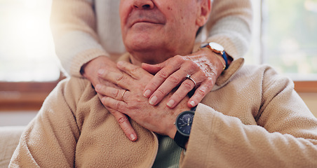 Image showing Hands, empathy and a senior couple closeup in their home for love, support or trust during retirement. Hope, healing and sympathy with elderly people on a sofa in the living room of their home