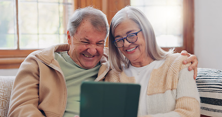 Image showing Tablet, conversation and senior couple on sofa in the living room networking on social media. Digital technology, bonding and elderly people in retirement scroll on mobile app or the internet at home