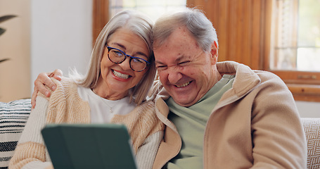 Image showing Tablet, social media and a senior couple laughing in the living room of their home together during retirement. Technology, love and relax with funny elderly people looking at a meme on the sofa