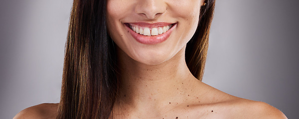 Image showing Dental, care and woman with a smile for teeth, healthcare and the dentist against a grey studio background. Happy, excited and girl model with medical cosmetics for cleaning of mouth for wellness