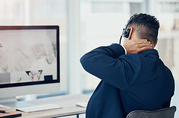 Image showing Neck pain, call center worker and tired employee man working in office chair the desk of online telemarketing sales business. CRM consultant, workplace injury and pinched nerve from company computer