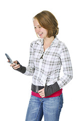 Image showing Teenage girl text messaging on a cell phone
