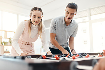 Image showing Office team, table soccer and team building while playing foosball game together for competition at work. Happy man and woman employees having fun in a casual and positive workplace for motivation