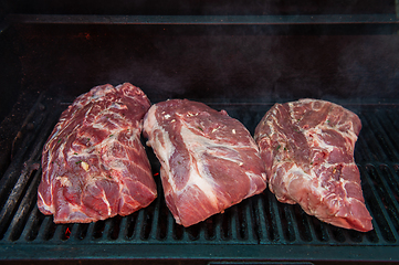 Image showing Pork meat steaks on the grill