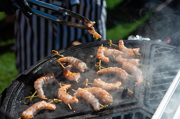 Image showing A professional cook prepares shrimps