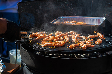 Image showing A professional cook prepares shrimps