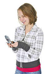 Image showing Teenage girl text messaging on a cell phone