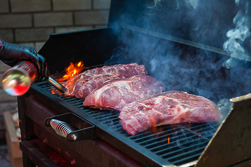 Image showing Pork meat steaks on the grill