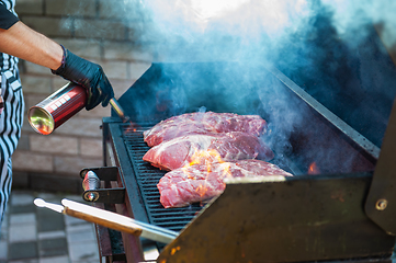 Image showing Pork meat steaks on the grill