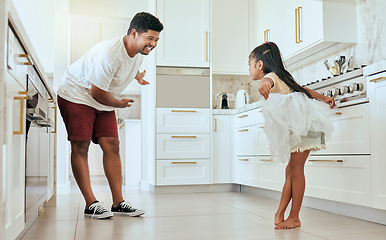 Image showing Family, dance and girl with father in kitchen for ballet, fun and bonding in their home together. Happy family, child and parent dancing, being creative and enjoying fantasy ballerina dancer practice