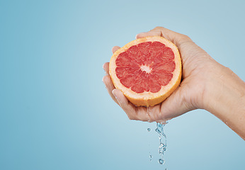 Image showing Grapefruit, food and wellness fruit juice of a woman hand with a healthy lifestyle. Model hands with fresh and organic produce for skincare, body and skin health with beauty and cosmetic treatment