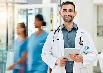 Image showing Healthcare, confidence and doctor with tablet in busy hospital with patient info or medical insurance documents online. Proud man, leader in medicine with support, trust and leadership at clinic.