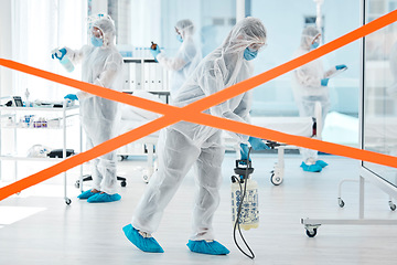 Image showing Covid, red tape and hospital people with healthcare crisis management cleaning workplace in face mask, safety gear and disinfectant. Clinic medical doctors, scientist team or group in ppe hazmat suit