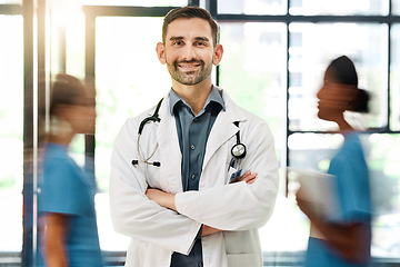 Image showing Doctor, hospital and medical insurance with stethoscope and healthcare worker happy about career choice, service or care. Portrait of male medicine or cardiology expert with busy staff for emergency