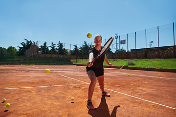 Image showing A young girl showing professional tennis skills in a competitive match on a sunny day, surrounded by the modern aesthetics of a tennis court.