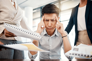 Image showing Businessman, stress and overwhelmed with headache, burnout or workload from colleagues at the office. Corporate man multi tasking suffering from mental health issues, overworked or tired at workplace