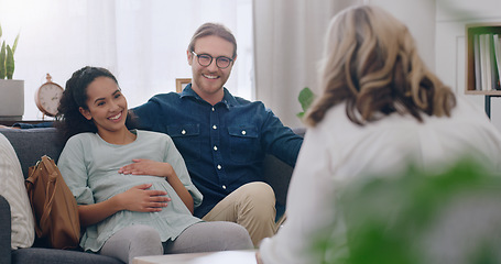 Image showing Pregnant, happy and couple in counseling with a psychologist consulting, listening and helping. Communication, pregnancy and healthy woman talking to a marriage therapist with partner for support